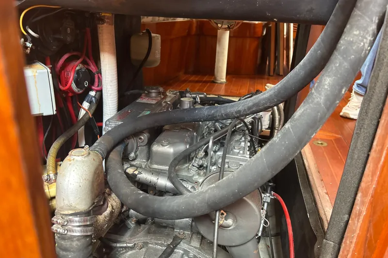 Slide: The Image of Engine compartment of a 1980 Hans Christian 43 sailboat, showing hoses and wiring. - 22