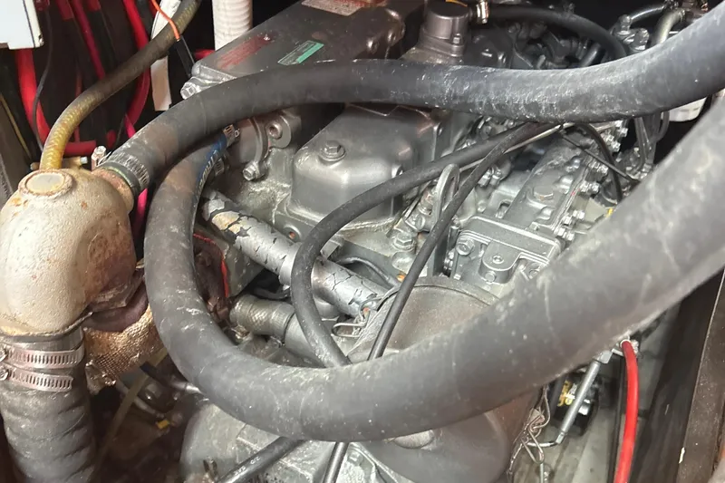 Slide: The Image of Engine compartment of a 1980 Hans Christian 43 sailboat, showing hoses and mechanical components. - 23