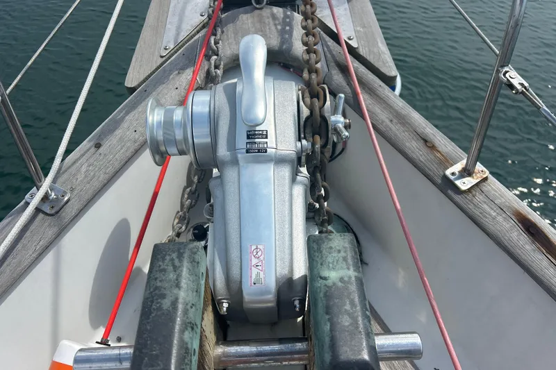 Slide: The Image of Anchor windlass on 1980 Hans Christian 43 sailboat, with visible chain and deck details. - 32