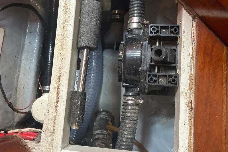 Slide: The Image of 1980 Hans Christian 43 boat interior showing plumbing and mechanical components. - 33