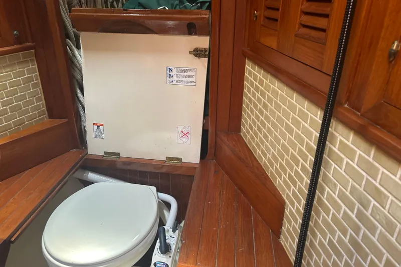 Slide: The Image of 1980 Hans Christian 43 yacht bathroom with wooden interior and marine toilet. - 34