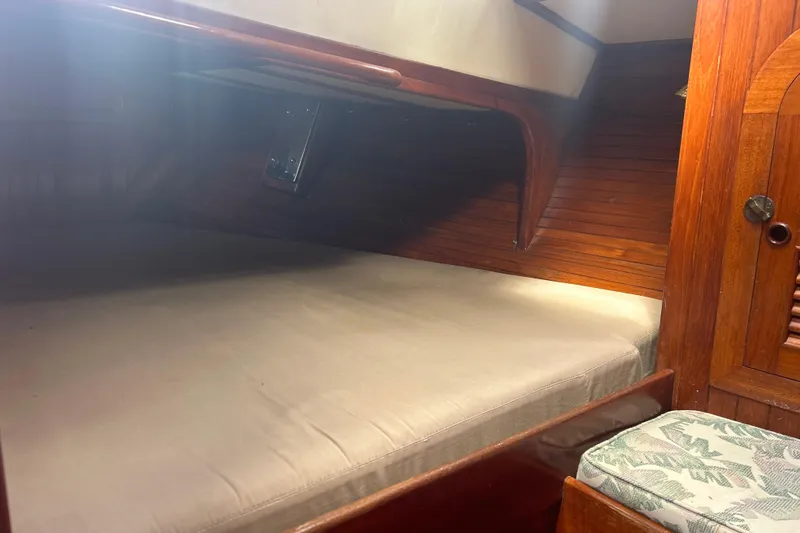 Slide: The Image of Cozy cabin interior of 1980 Hans Christian 43 sailboat with wooden finish and cushioned berth. - 35