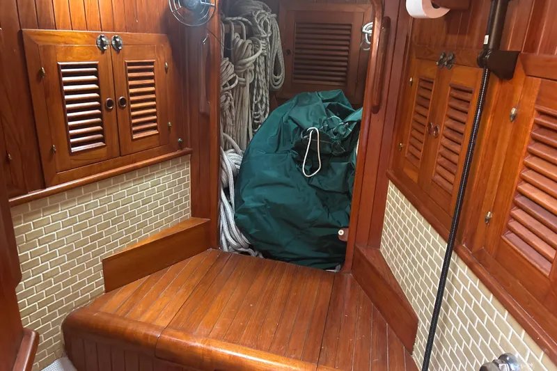 Slide: The Image of Interior of 1980 Hans Christian 43 sailboat with wooden cabinetry and nautical ropes. - 36