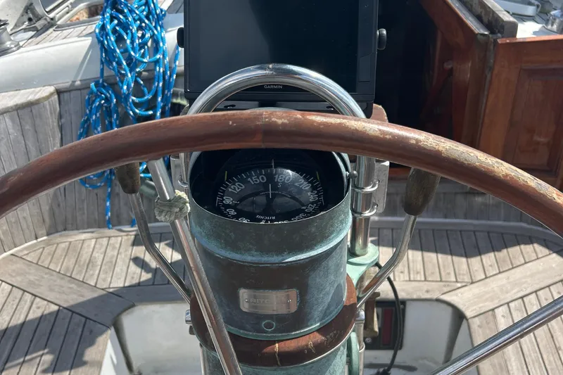 Slide: The Image of Steering wheel and compass on 1980 Hans Christian 43 sailboat deck. - 39