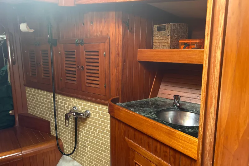 Slide: The Image of Interior of 1980 Hans Christian 43 sailboat with wooden cabinetry and sink. - 40