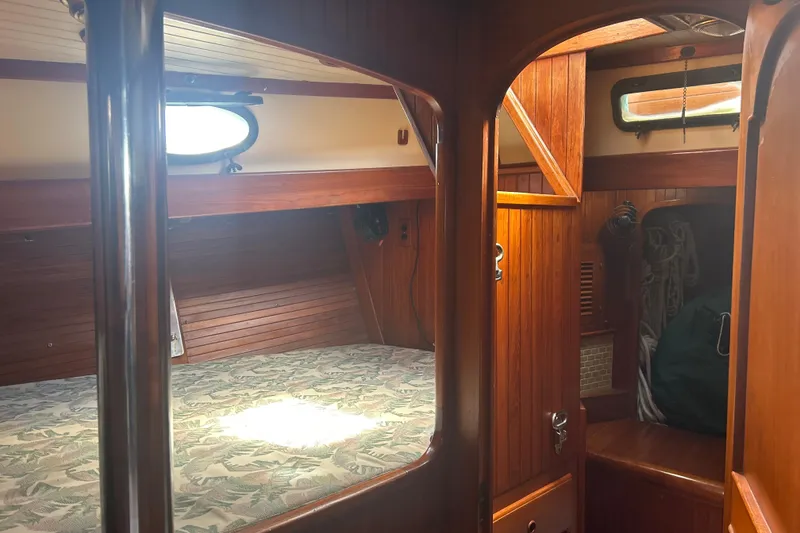 Slide: The Image of Cozy 1980 Hans Christian 43 yacht cabin with wooden interior and bedding. - 41
