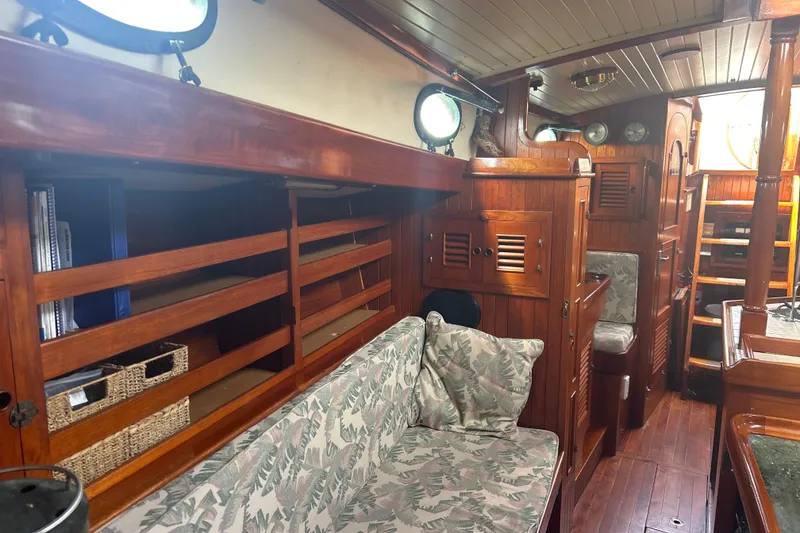 Slide: The Image of Interior of 1980 Hans Christian 43 sailboat with wooden finish and cozy seating area. - 42