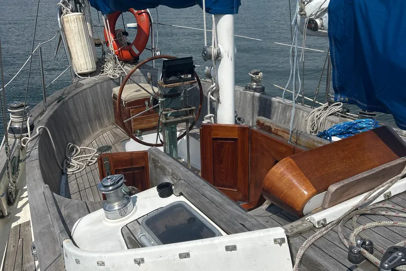 Slide: The Image of Cockpit of a 1980 Hans Christian 43 sailboat with wooden details and nautical equipment. - 43