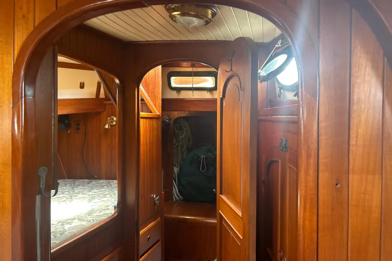 Slide: The Image of Interior of 1980 Hans Christian 43 sailboat with wooden paneling and cozy cabin. - 45