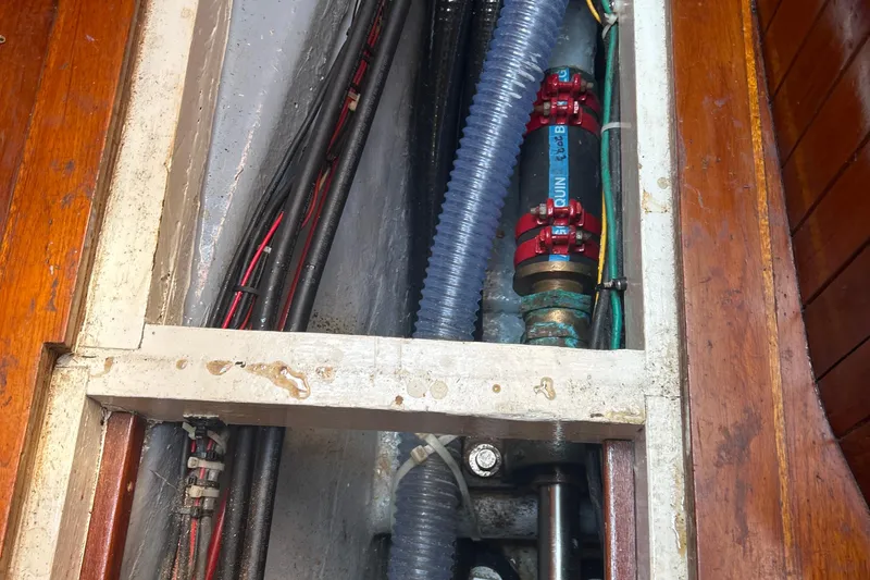 Slide: The Image of Interior view of a 1980 Hans Christian 43 sailboat showing plumbing and wiring. - 50