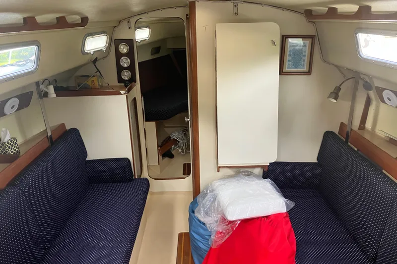 Slide: The Image of Interior of 1983 Pearson 303 Sloop sailboat with cozy seating and nautical decor. - 7