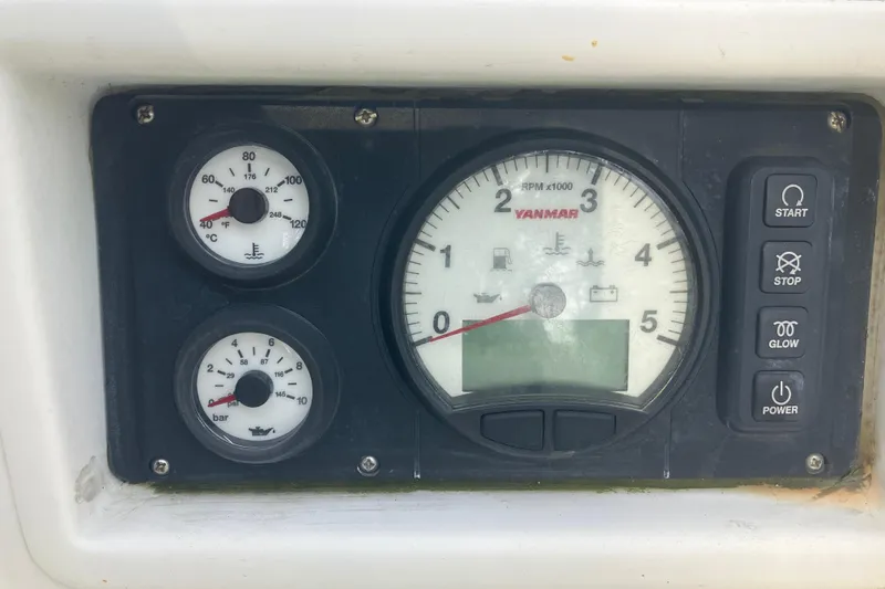 Slide: The Image of Control panel of a 1983 Pearson 303 Sloop with Yanmar engine gauges and buttons. - 2