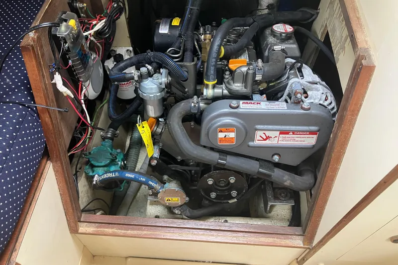 Slide: The Image of Engine compartment of a 1983 Pearson 303 Sloop sailboat, showing detailed mechanical components. - 3