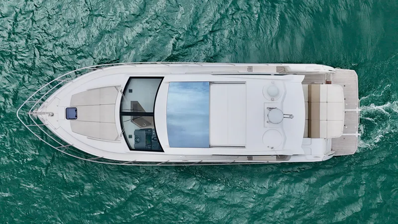 Slide: The Image of Overhead view of a 2016 Absolute Sport Yacht cruising on turquoise water. - 13