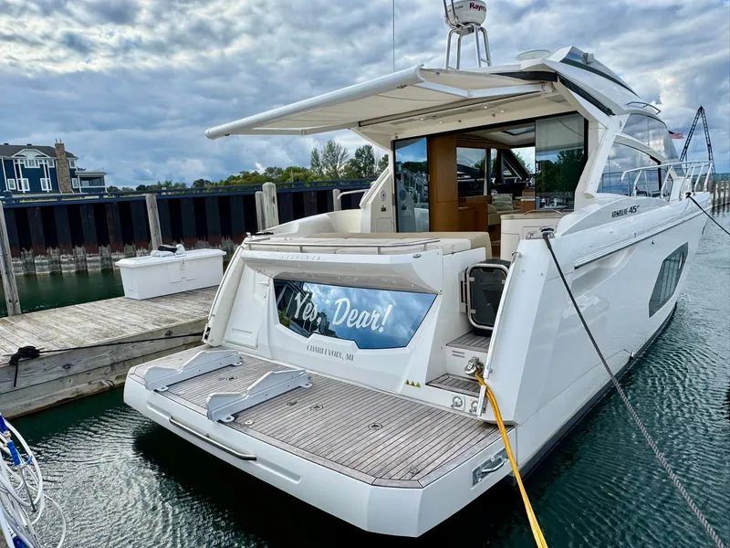 Slide: The Image of 2016 Absolute Sport Yacht docked, rear view with open deck and water reflections. - 20
