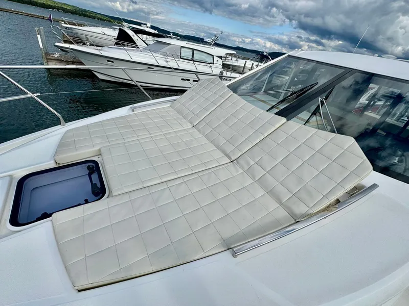 Slide: The Image of 2016 Absolute Sport Yacht with cushioned sunbathing area, docked at marina. - 35