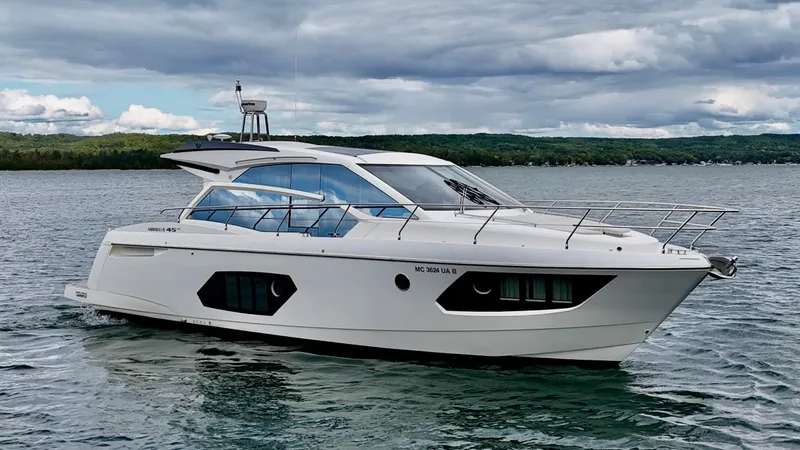 Slide: The Image of 2016 Absolute Sport Yacht cruising on a scenic lake under cloudy skies. - 5