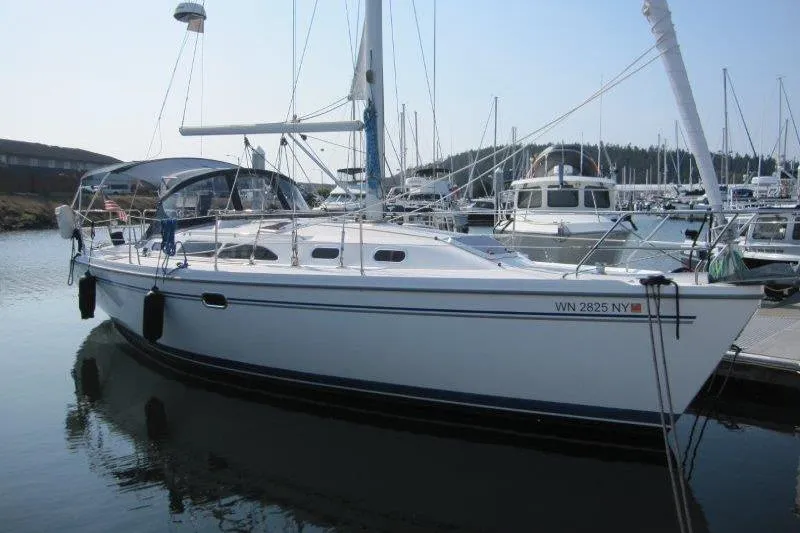 The Image of 2004 Catalina 350 MkII sailboat docked in a marina, surrounded by other boats. - 0