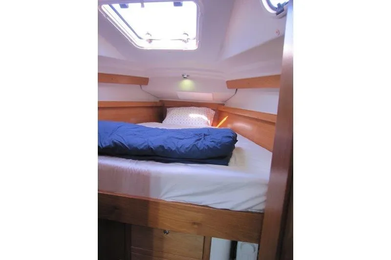 Slide: The Image of Cozy cabin interior of 2004 Catalina 350 MkII sailboat with bedding and natural light. - 11