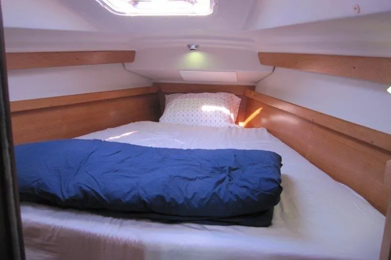 Slide: The Image of Cozy cabin interior of 2004 Catalina 350 MkII sailboat with bed and bedding. - 12
