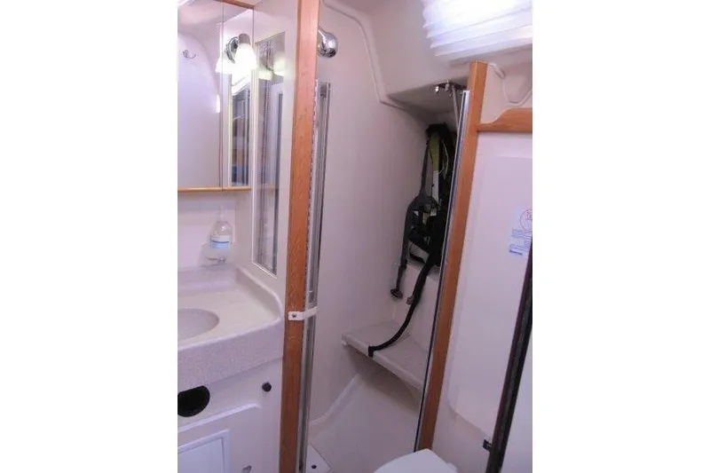 Slide: The Image of 2004 Catalina 350 MkII yacht bathroom with sink, mirror, and shower area. - 14