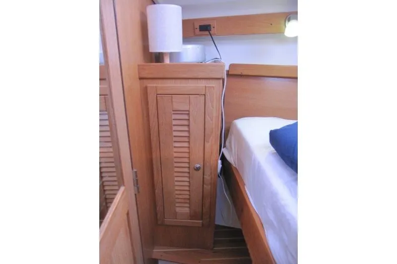 Slide: The Image of Interior of 2004 Catalina 350 MkII yacht with wooden cabinet and bed. - 16