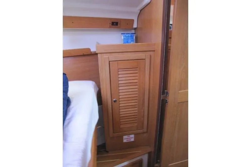 Slide: The Image of Interior of 2004 Catalina 350 MkII sailboat with wooden cabinet and bed. - 17