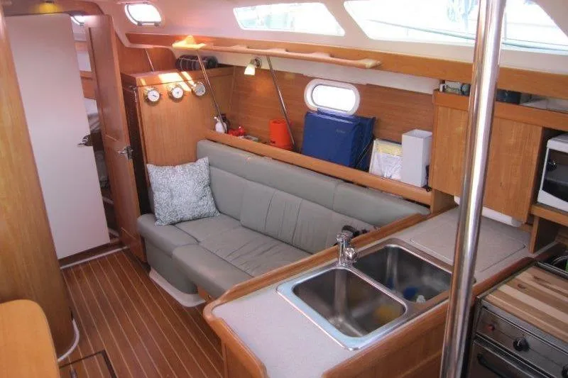 Slide: The Image of Interior of 2004 Catalina 350 MkII sailboat with cozy seating and kitchen area. - 2