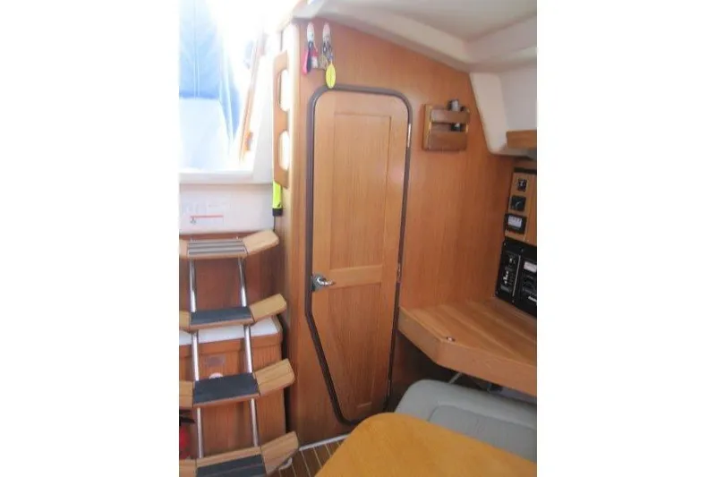 Slide: The Image of Interior of 2004 Catalina 350 MkII sailboat with wooden door and steps. - 20