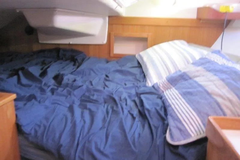 Slide: The Image of Cozy cabin interior of a 2004 Catalina 350 MkII sailboat with blue bedding. - 22