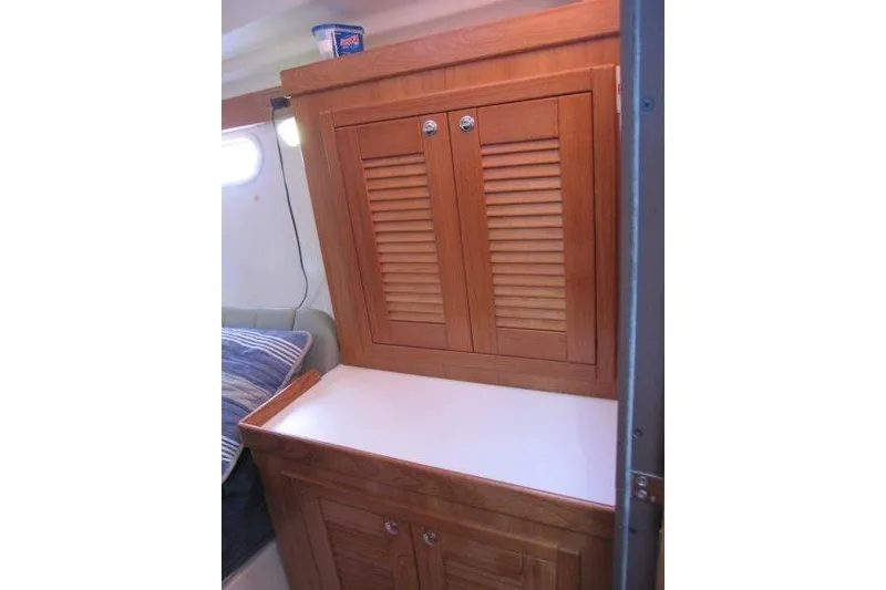 Slide: The Image of 2004 Catalina 350 MkII interior with wooden cabinet and white countertop. - 23