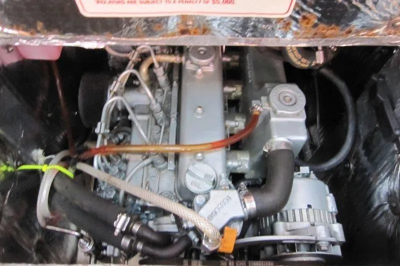 Slide: The Image of Engine compartment of a 2004 Catalina 350 MkII sailboat, showcasing mechanical components. - 24