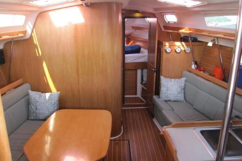 Slide: The Image of Interior of a 2004 Catalina 350 MkII sailboat with wood finish and cozy seating area. - 3