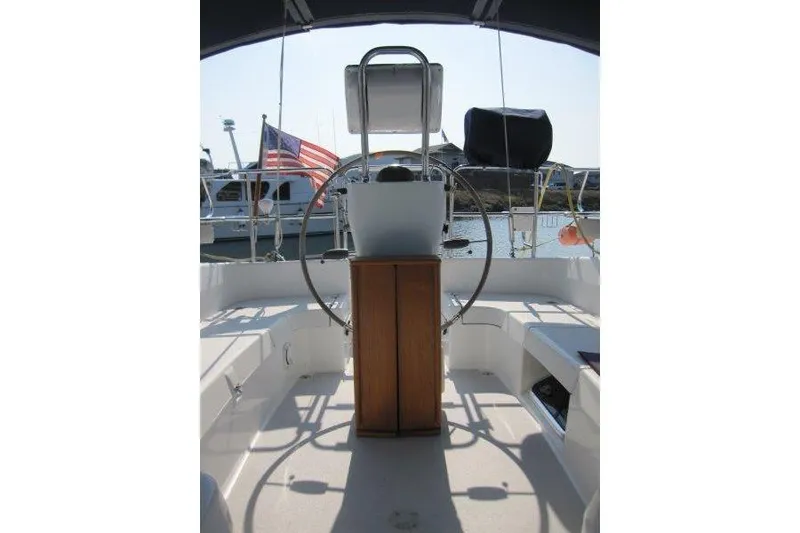 Slide: The Image of Cockpit view of 2004 Catalina 350 MkII sailboat with steering wheel and American flag. - 31