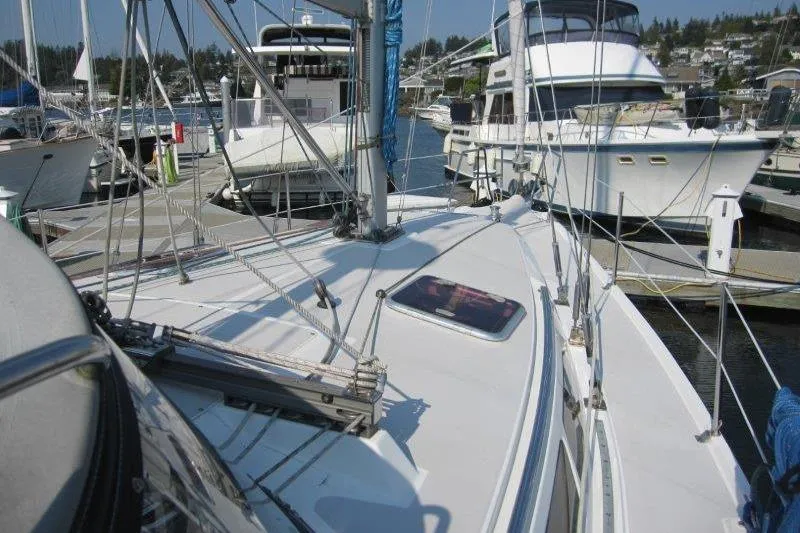 Slide: The Image of 2004 Catalina 350 MkII sailboat docked in a marina, surrounded by other boats. - 37