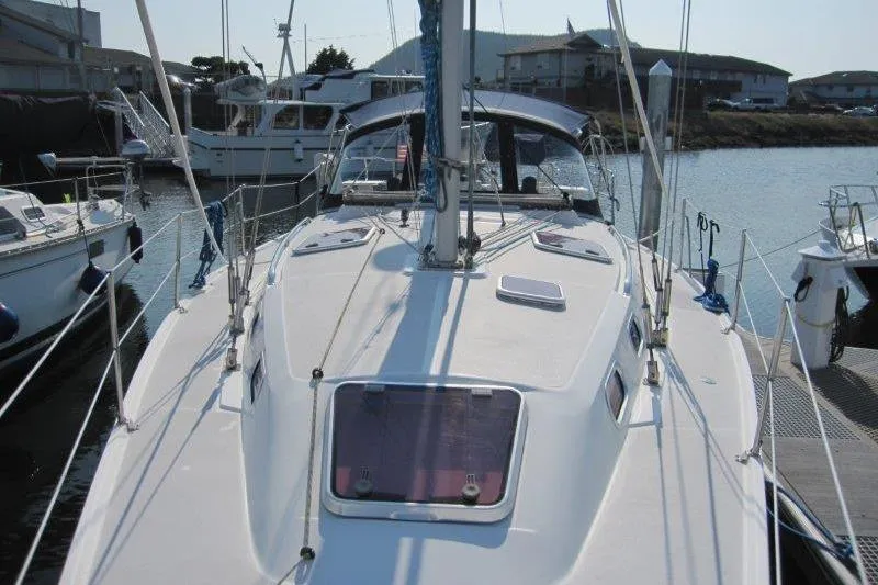 Slide: The Image of 2004 Catalina 350 MkII sailboat docked in a marina, showcasing deck and rigging. - 39