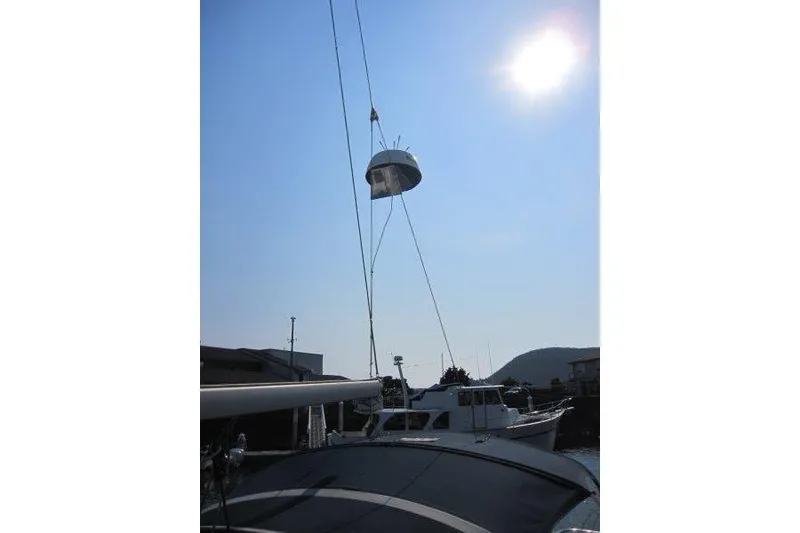 Slide: The Image of Catalina 350 MkII sailboat mast with hoisted equipment under bright sun, 2004 model. - 41