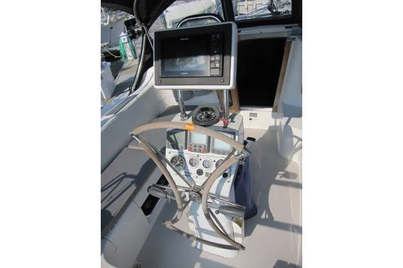 Slide: The Image of Cockpit of 2004 Catalina 350 MkII sailboat with navigation equipment and steering wheel. - 48
