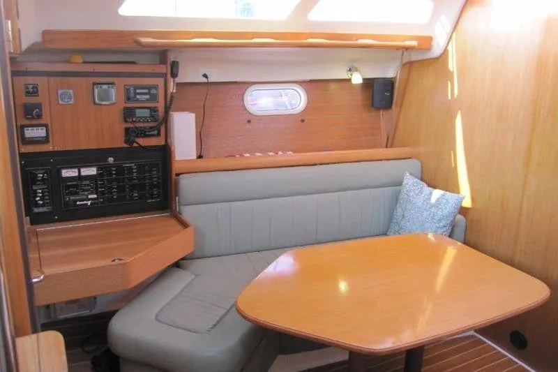 Slide: The Image of Interior of 2004 Catalina 350 MkII sailboat with navigation station and cozy seating area. - 5