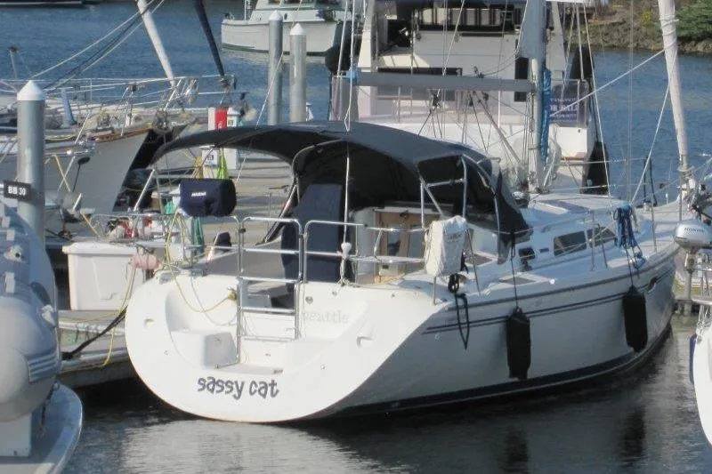 Slide: The Image of 2004 Catalina 350 MkII sailboat named "Sassy Cat" docked in a marina. - 52