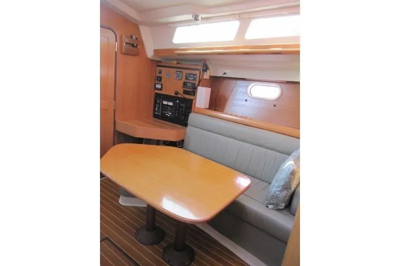 Slide: The Image of Interior of 2004 Catalina 350 MkII sailboat with dining area and navigation panel. - 7