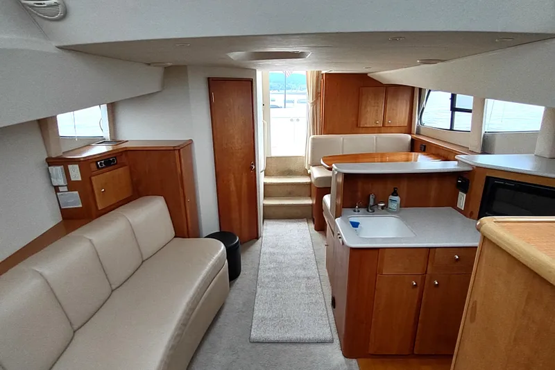 Slide: The Image of 2003 Silverton 330 Sport Bridge interior with modern kitchen and comfortable seating. - 17