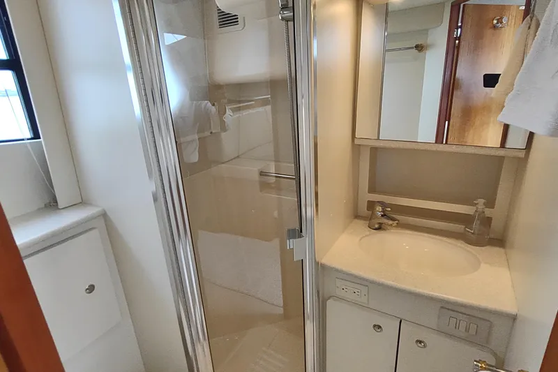 Slide: The Image of Bathroom interior of 2003 Silverton 330 Sport Bridge yacht, featuring shower and sink. - 23