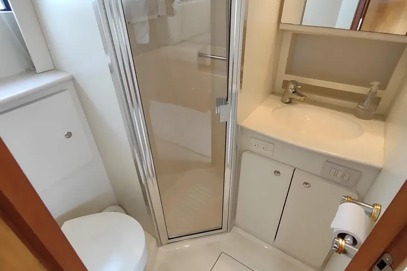 Slide: The Image of 2003 Silverton 330 Sport Bridge bathroom with shower, sink, and toilet. - 24
