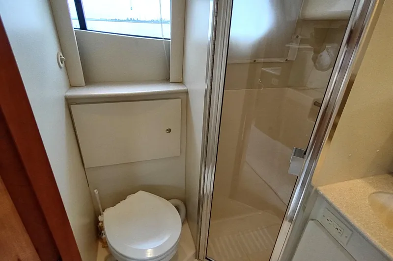 Slide: The Image of 2003 Silverton 330 Sport Bridge bathroom with toilet and shower enclosure. - 25