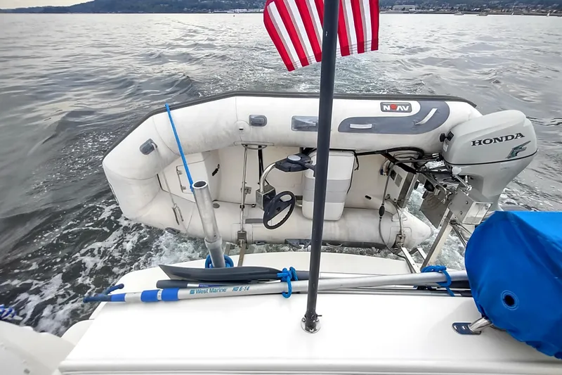 Slide: The Image of 2003 Silverton 330 Sport Bridge with inflatable boat and Honda motor on water. - 30