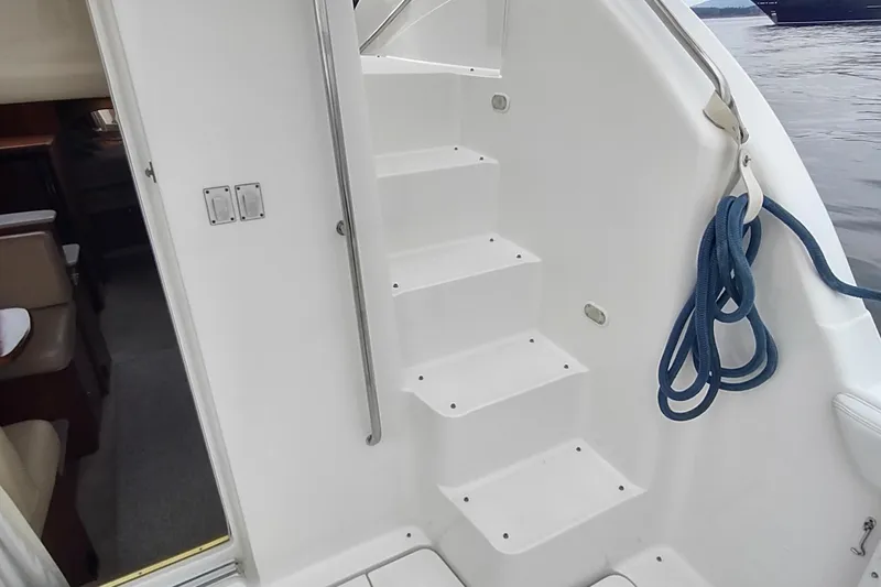 Slide: The Image of Staircase on 2003 Silverton 330 Sport Bridge yacht with blue rope and interior view. - 33