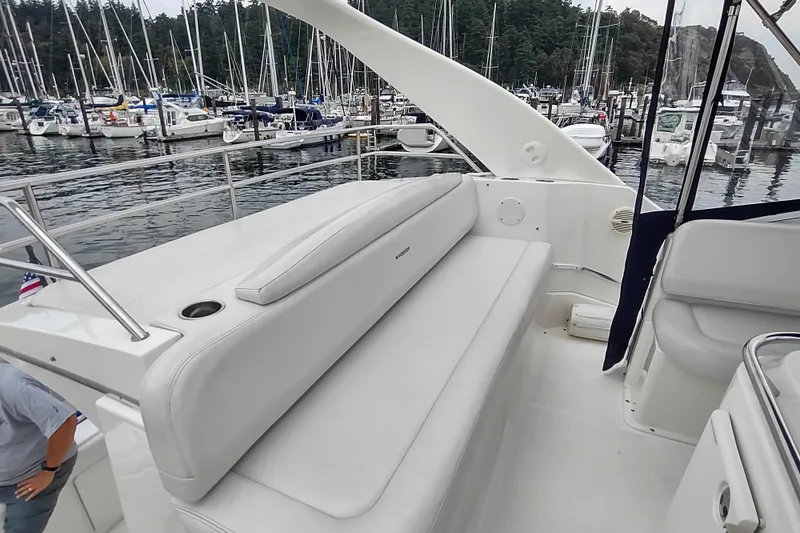 Slide: The Image of 2003 Silverton 330 Sport Bridge yacht with white seating, docked at a marina. - 39