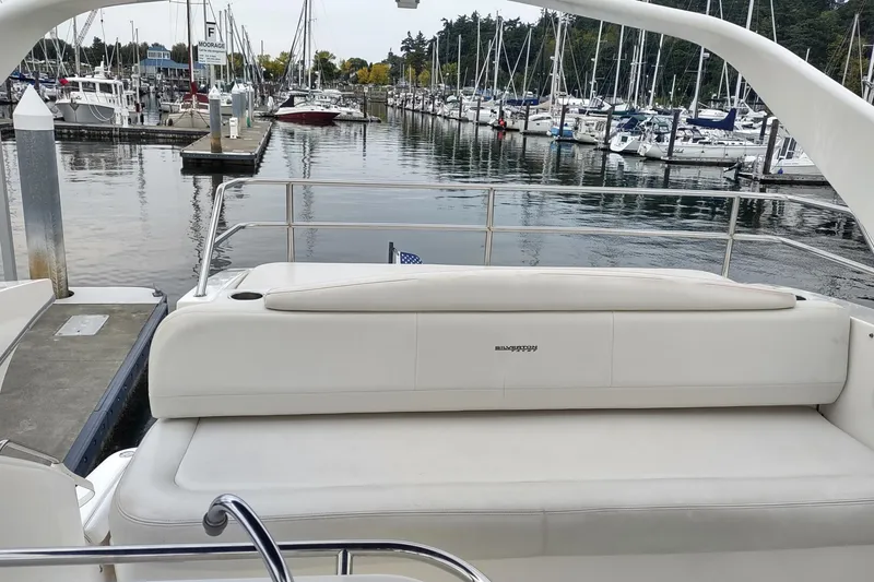 Slide: The Image of 2003 Silverton 330 Sport Bridge yacht docked at a marina with surrounding boats. - 41