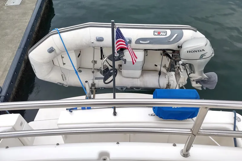 Slide: The Image of 2003 Silverton 330 Sport Bridge with inflatable dinghy and Honda outboard motor. - 42